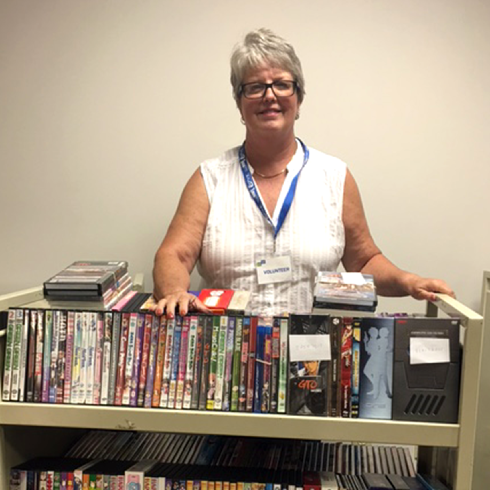 Volunteer with a cart of books