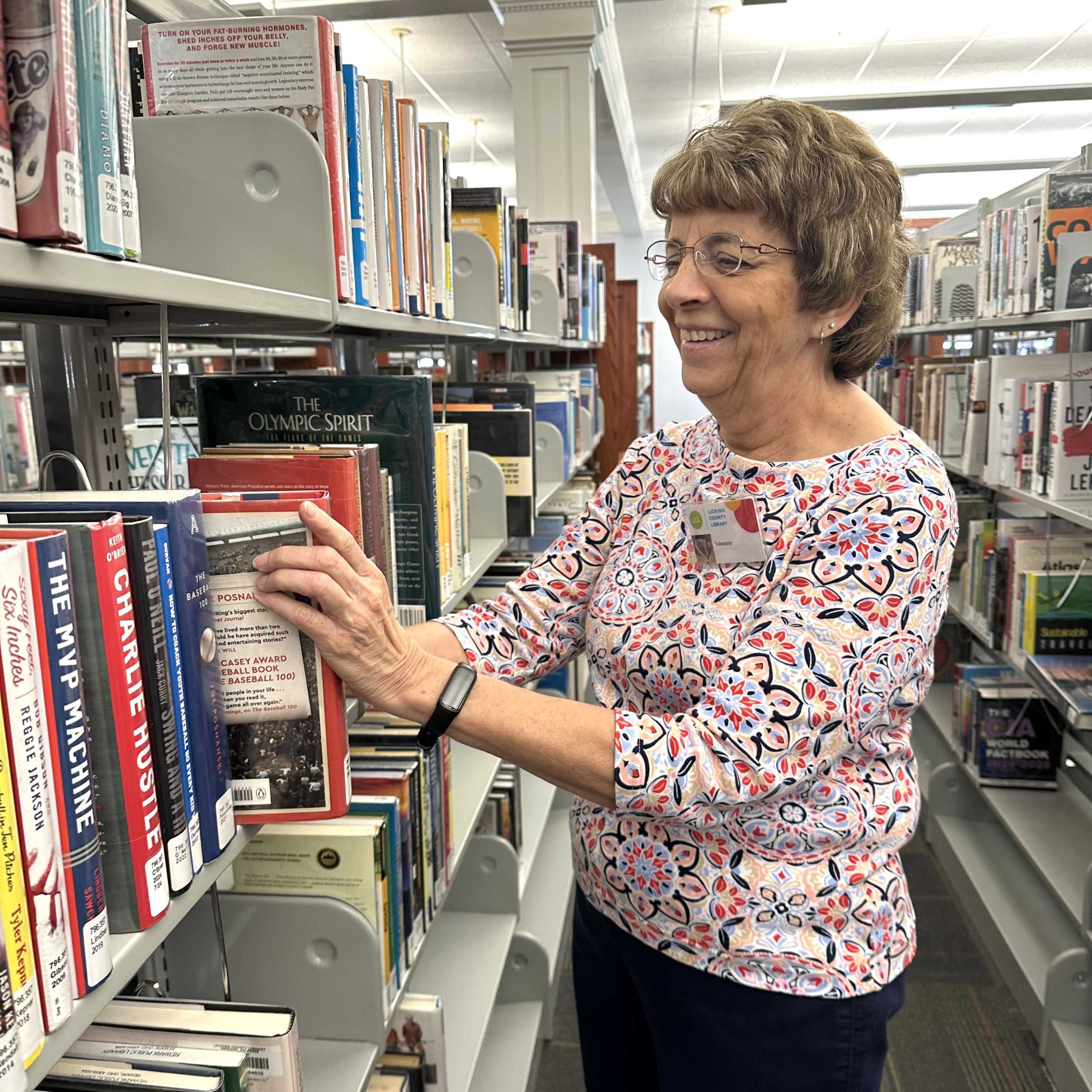 Volunteer shelving a book