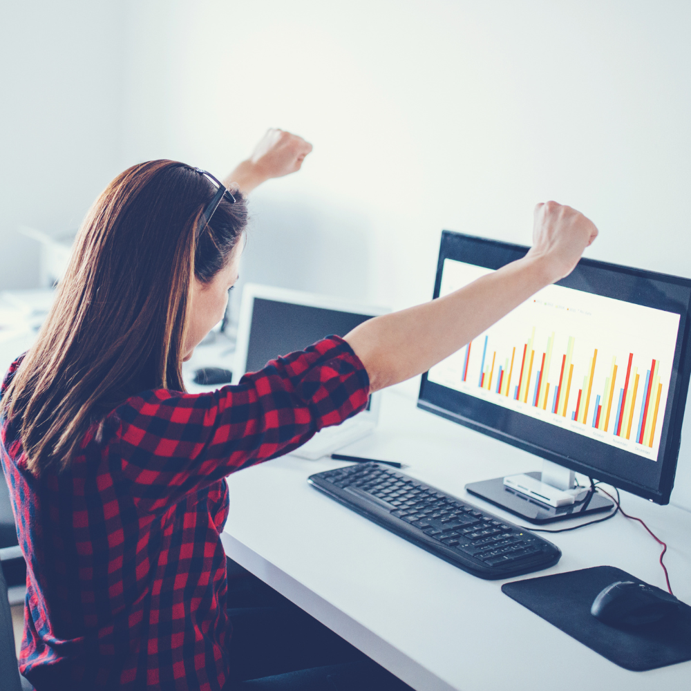 Happy woman in front of computer