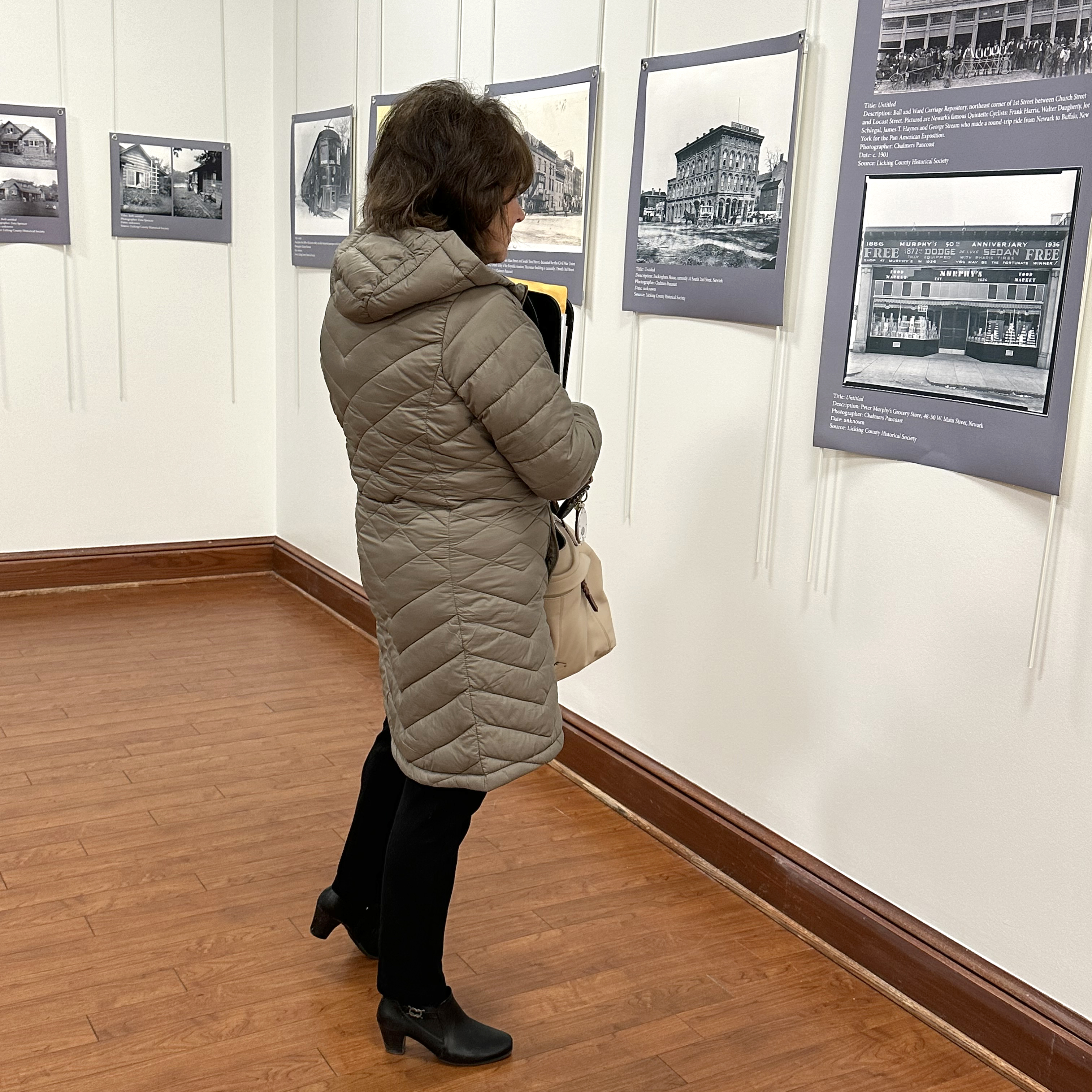 lady looking at a photograph in an art gallery