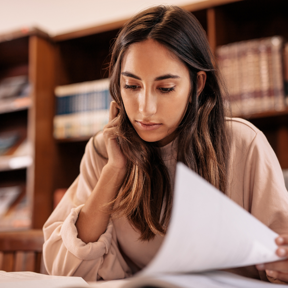 Woman studying and researching at library
